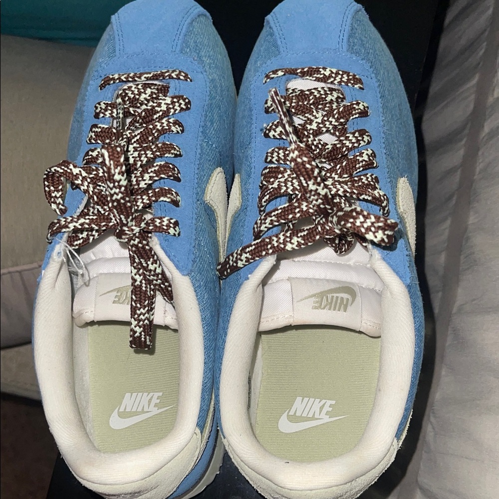 Nike Cortez Light Blue Suede NikeSneakers with Brown Patterned Laces.
